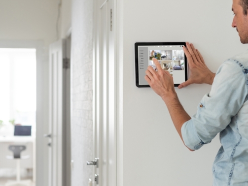 Man,Using,Tablet,Panel,Application,For,Control,Smart,Home,Living.